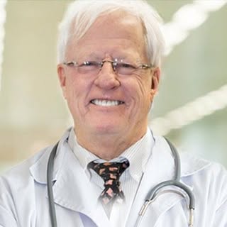 Dr. Nordt in a white coat with a stethoscope, smiling